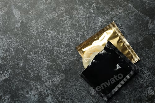 Preview: Condoms on black smokey background, space for text