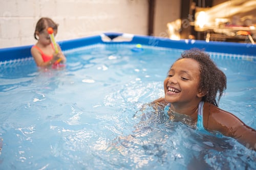Preview: Children playing happily in an indoor pool during summer