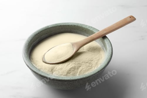 Preview: Bowl and spoon of agar-agar powder on white marble table