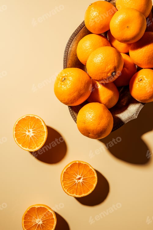 Preview: Flat lay with tangerines in metal bowl on beige backdrop