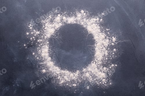 Preview: Baking or cooking background, flour on the dark background.