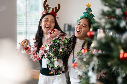 Preview: Festive Celebration with Friends Wearing Christmas Accessories and Decorating a Christmas Tree