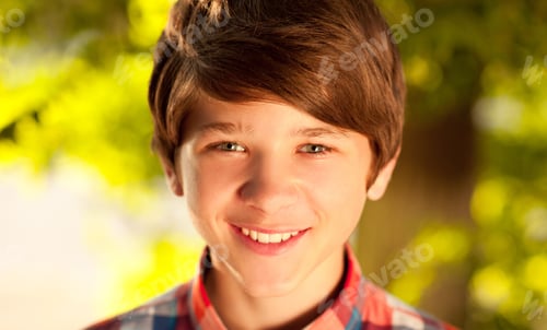 Preview: Smiling teenage boy posing over nature background outdoors. Looking at camera. Childhood.