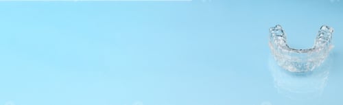 Preview: Banner with dental teeth aligners or invisible braces for straightening teeth on the blue background