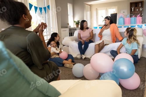Preview: Celebrating baby shower, friends with balloons and gifts sharing joyful conversation