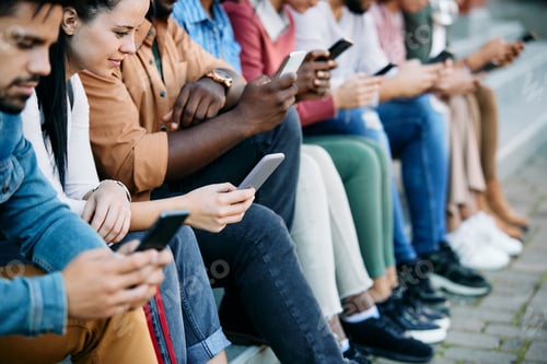 Preview: Large group of students using their smart phones at campus.