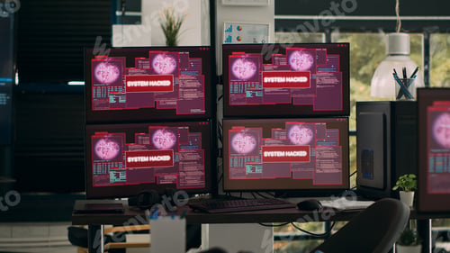 Preview: Multiple monitors with critical error message flashing on screens with hacking alert