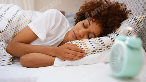 Preview: Woman At Home Asleep In Bed With Alarm Clock On Bedside Table