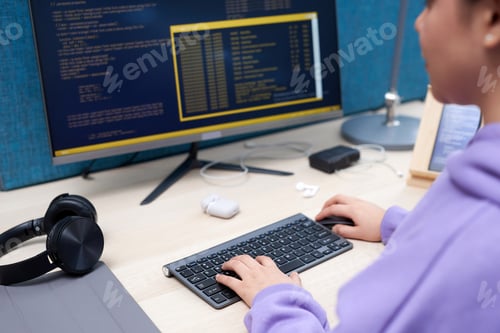 Preview: Close up of female IT professional writing code at office workplace