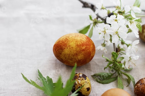 Preview: Modern easter eggs with spring flowers on rustic linen cloth, copy space. Happy Easter! Aesthetic