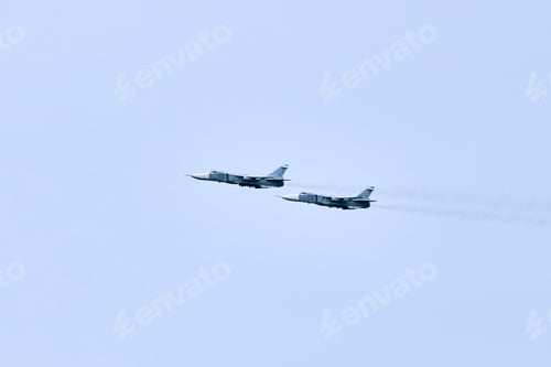 Preview: Two Russian military fighter planes armed with missiles flies in blue sky, airborne mission