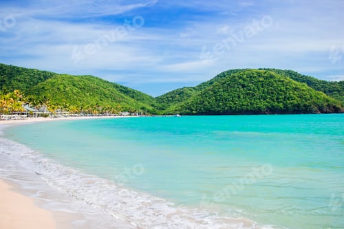 Preview: Idyllic tropical Carlisle bay beach with white sand, turquoise ocean water and blue sky at Antigua