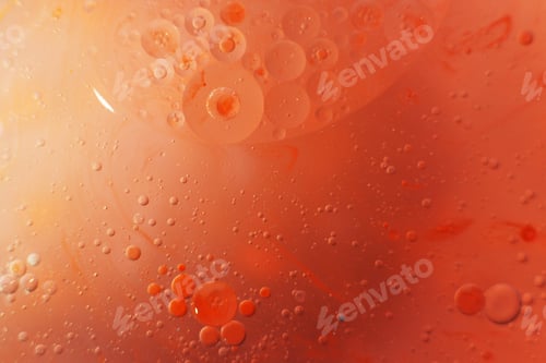 Preview: Gold and red Oil bubbles close up. circles of orange and pink water macro. abstract shiny background