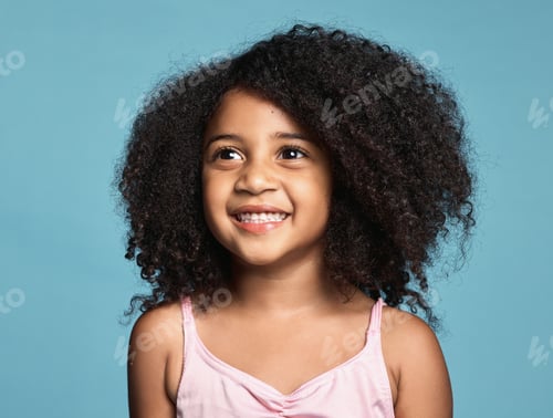 Preview: Happy, smile and girl child in a studio with afro hair standing by a blue background alone. Happines