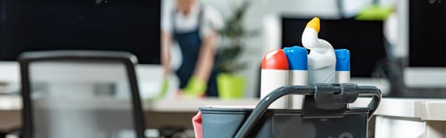 Preview: panoramic shot of cart with different cleaning supplies used by cleaning company workers
