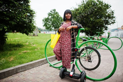 Preview: African american woman using segway or hoverboard