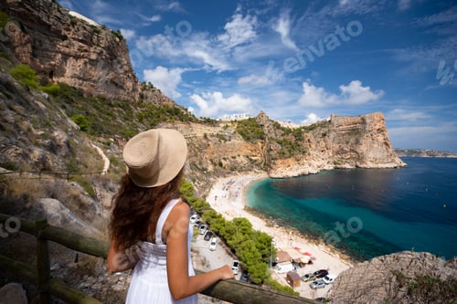 Preview: Brunette girl in a hat resting on the coast of Spain