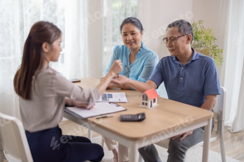 Preview: Elderly couples satisfying retirement home purchase with contract and key handover from a saleswoman