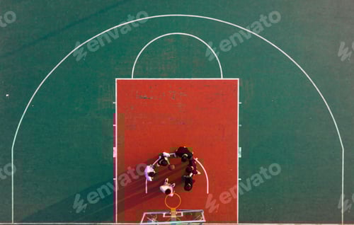 Preview: Aerial view of people playing a game of basketball on an outdoor court