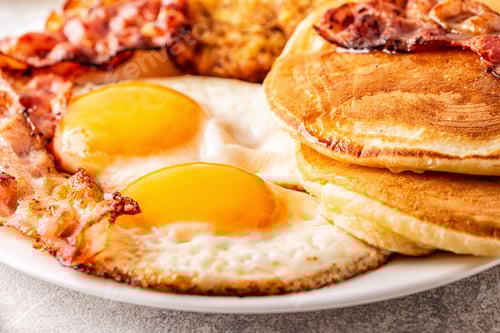 Preview: Healthy Full American Breakfast with Eggs Bacon Pancakes and Latkes.