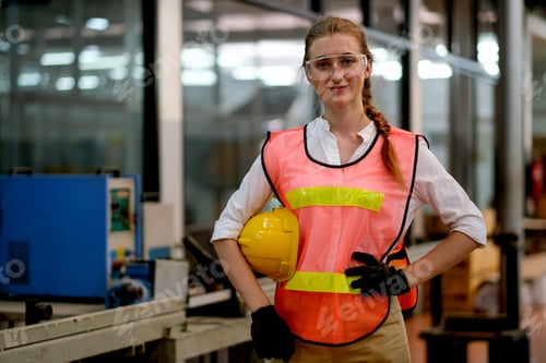 Preview: Pretty technician or engineer or worker action of akimbo and hold yellow helmet stand and smile