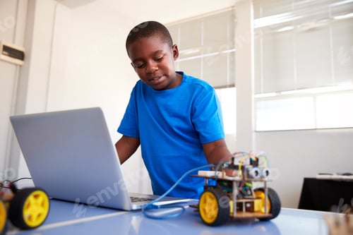 Preview: Male Student Building And Programing Robot Vehicle In After School Computer Coding Class