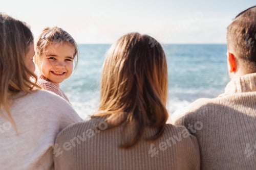 Preview: Man, woman, teenager and little child by the sea. Mom, dad and female teen standing back.