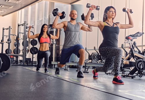 Preview: Male and two slim females doing squats.