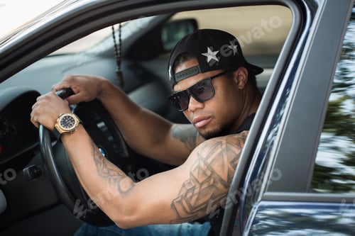Preview: Young african male driver driving a car