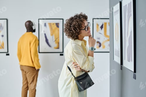 Preview: Woman examining modern art at gallery