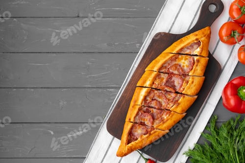 Preview: Turkish stuffed flatbread pide on gray wooden table
