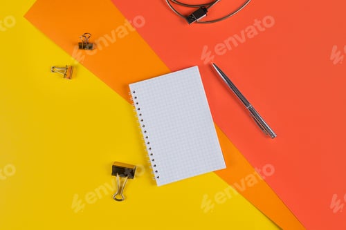 Preview: Yellow office desk table with blank notebook and other office supplies