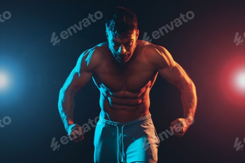 Preview: Shirtless handsome muscle man posing in the studio