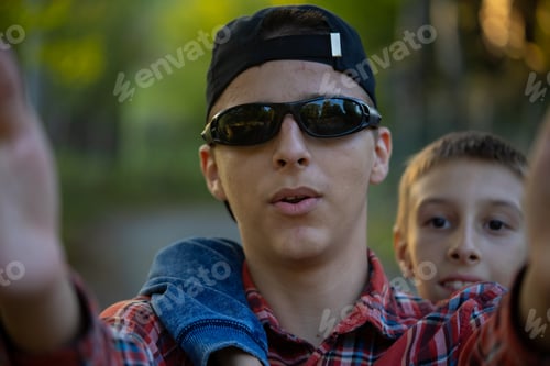 Preview: Group of male children, brothers together making selfie in nature