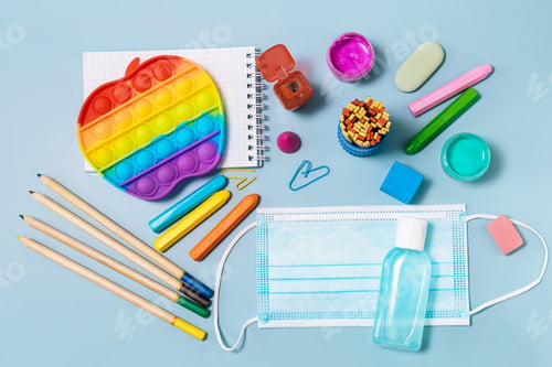 Preview: School supplies, face mask, bottle of sanitizer.