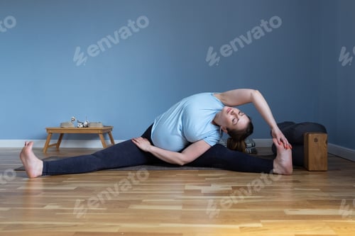 Preview: woman doing yoga Wide-Angle Seated Forward Bend pose, Upavishtha Konasana