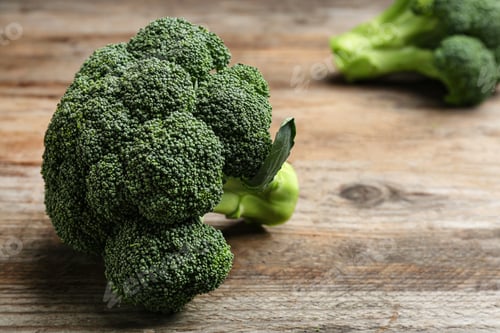 Preview: Fresh broccoli on wooden table, closeup with space for text