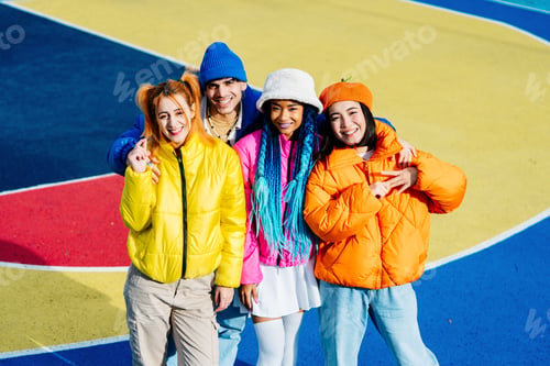 Preview: Multiracial group of young friends meeting outdoors in winter