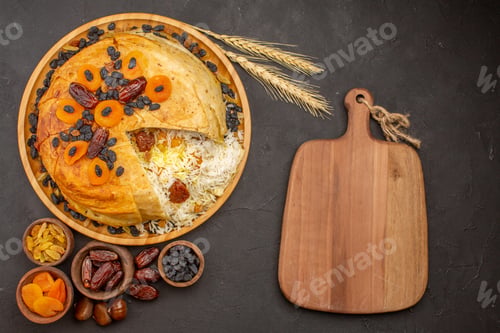 Preview: top view tasty shakh plov with raisins and dried apricots on grey background rice dinner meal