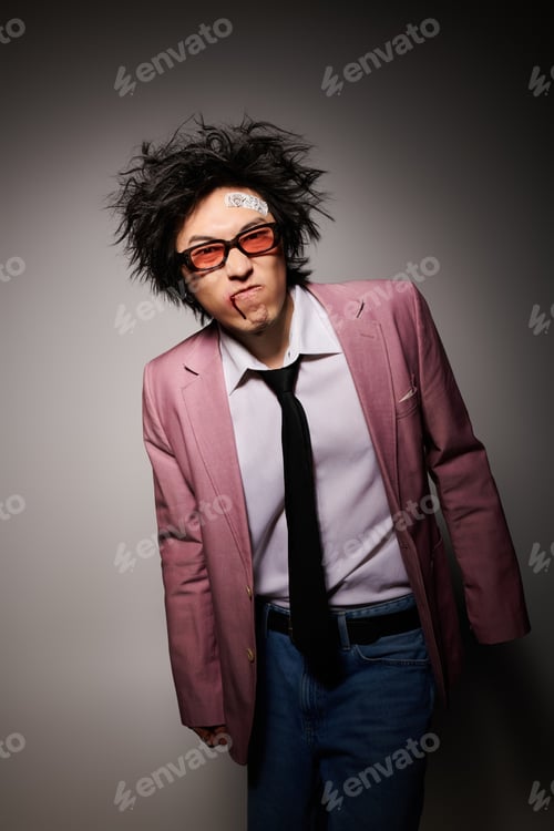 Preview: Stylish Asian man showcasing spring fashion in a modern studio setting