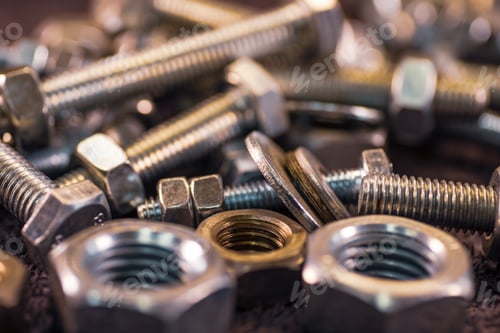Preview: Metal chrome bolts and nuts in a chaotic order industrial background