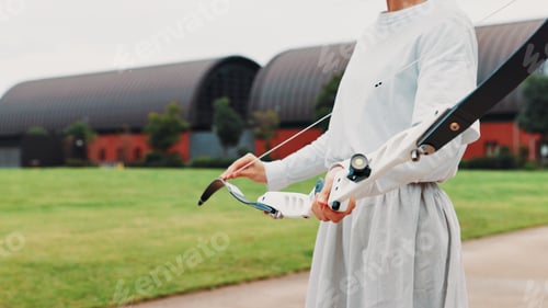 Preview: Archery, sport and hands with bow outdoor for shooting practice, martial arts tradition or getting