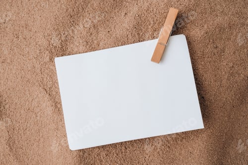 Preview: Sheet of white paper with copy space clothespin on sand. Summer vacation holiday concept. Planning t