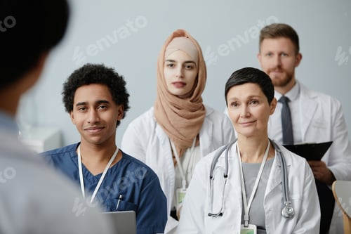 Preview: Group of smiling doctors in audience at conference