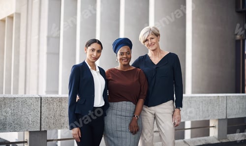 Preview: Portrait of a group of businesswomen standing together against a city background