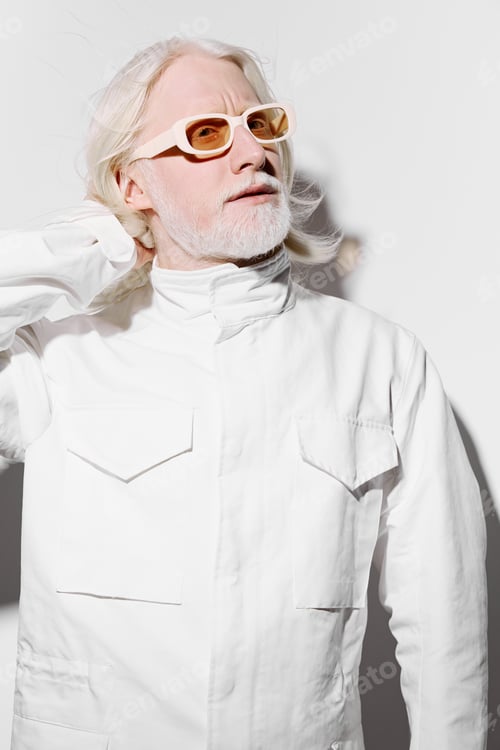 Preview: Fashion portrait of a mature man with long white hair and stylish glasses, dressed in a white jacket