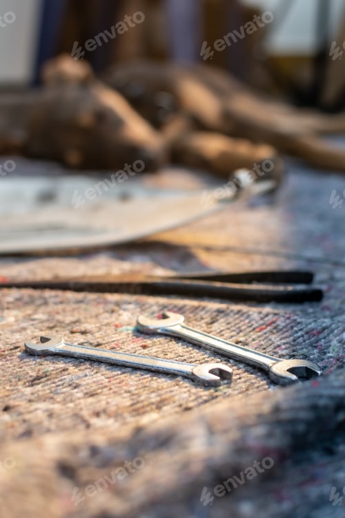 Preview: Close-up of two wrenches, in an outdoor workshop, in the background a dog.