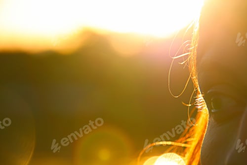 Preview: Closeup shot of a beautiful woman's eye lit by sunlight