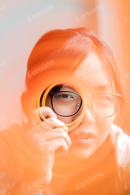 Preview: Blurred and filtered head shot of a girl wearing eyeglasses with her eye in focused and unfiltered