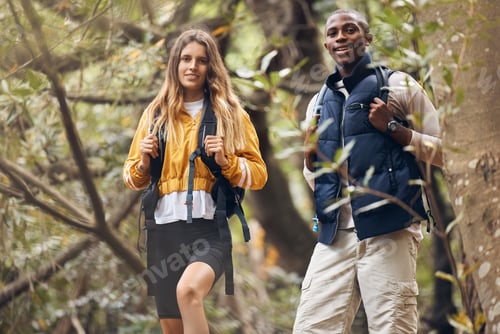 Preview: Portrait of interracial couple hiking in a nature forest environment or woods together in spring. M